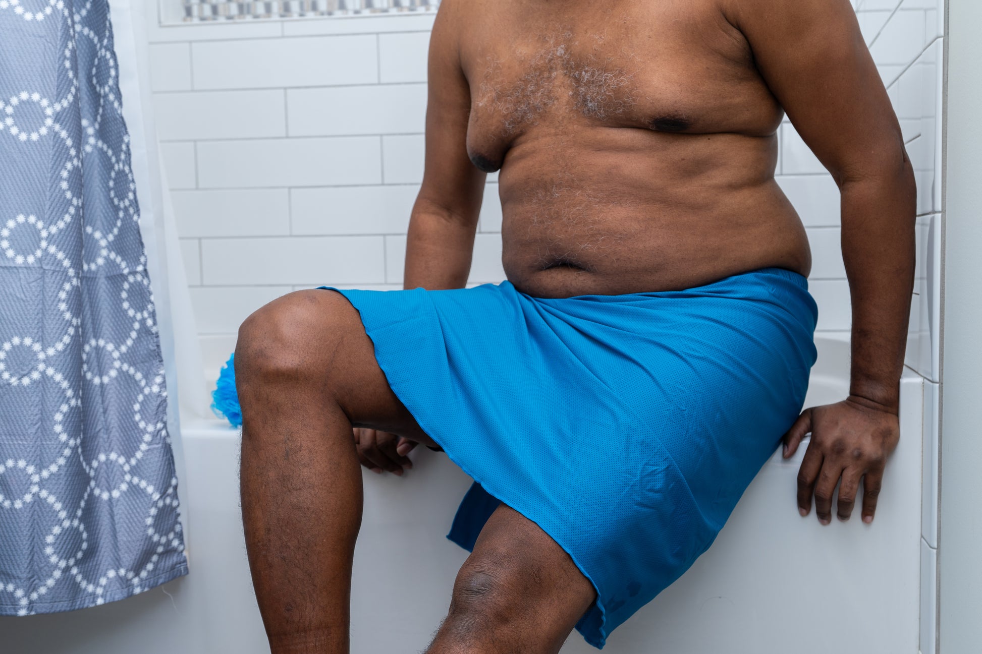 Male sitting on edge of bathtub with Wrap on 