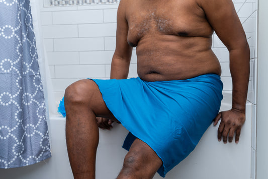 Male sitting on edge of bathtub with Wrap on 